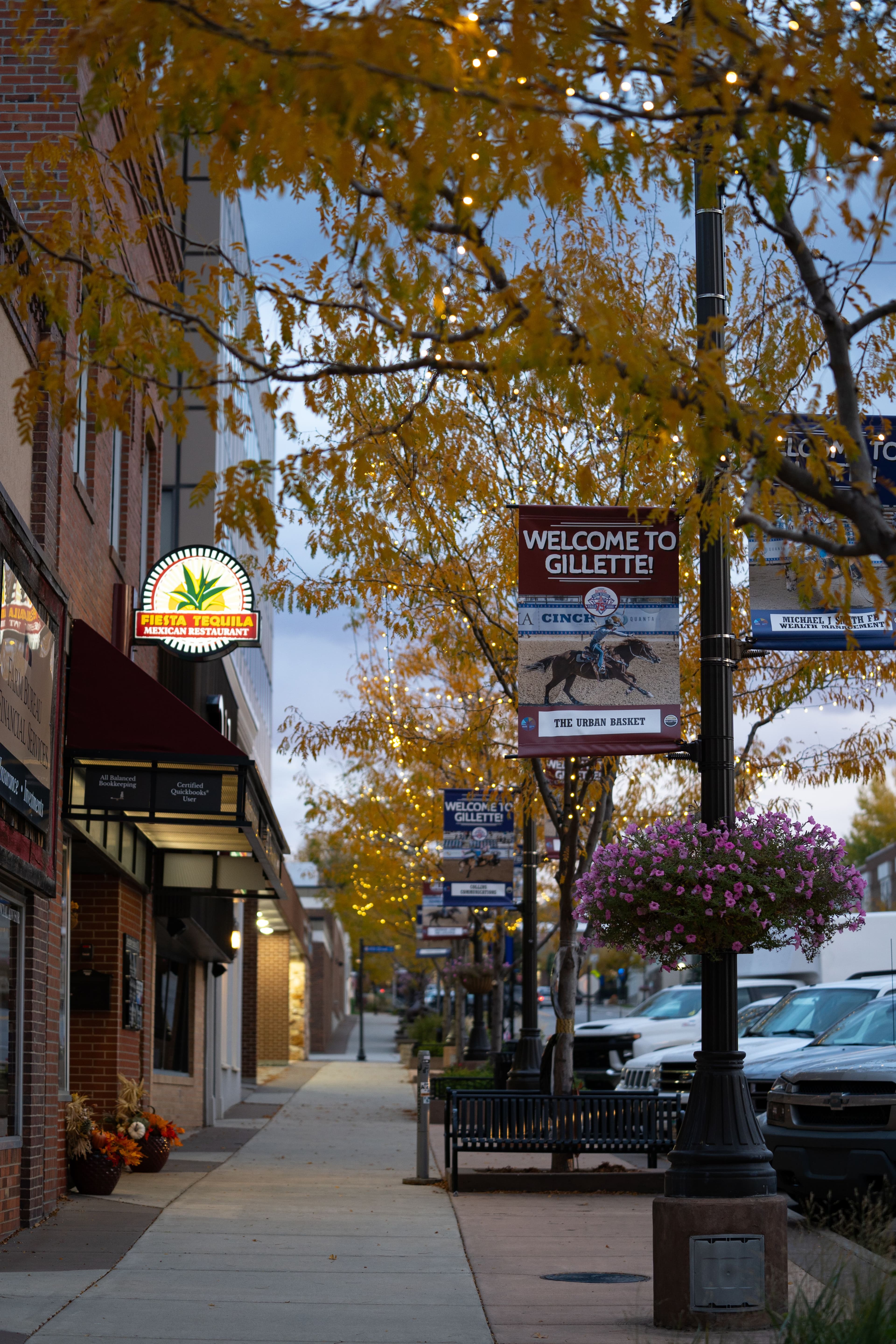 Welcome to Gillette signage on small town street in early evening during fall