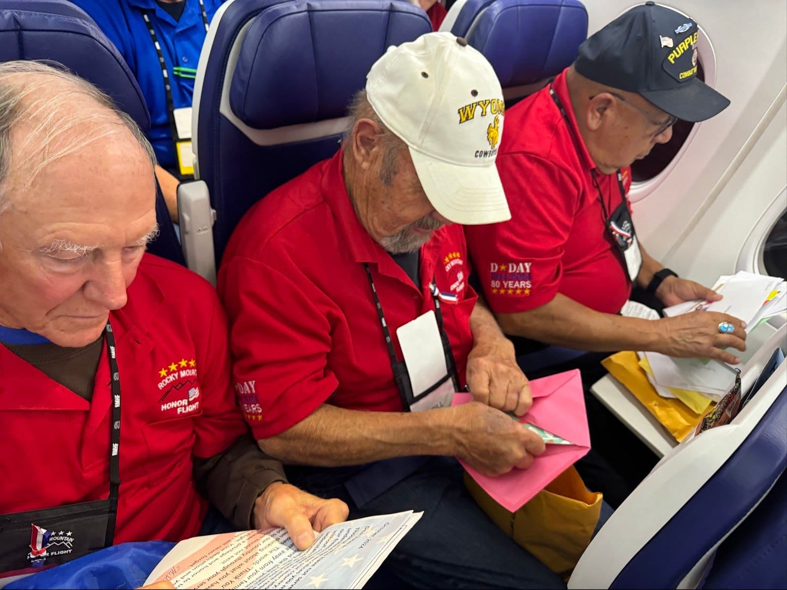 Veterans reading "Mail Call" letters on the flight home