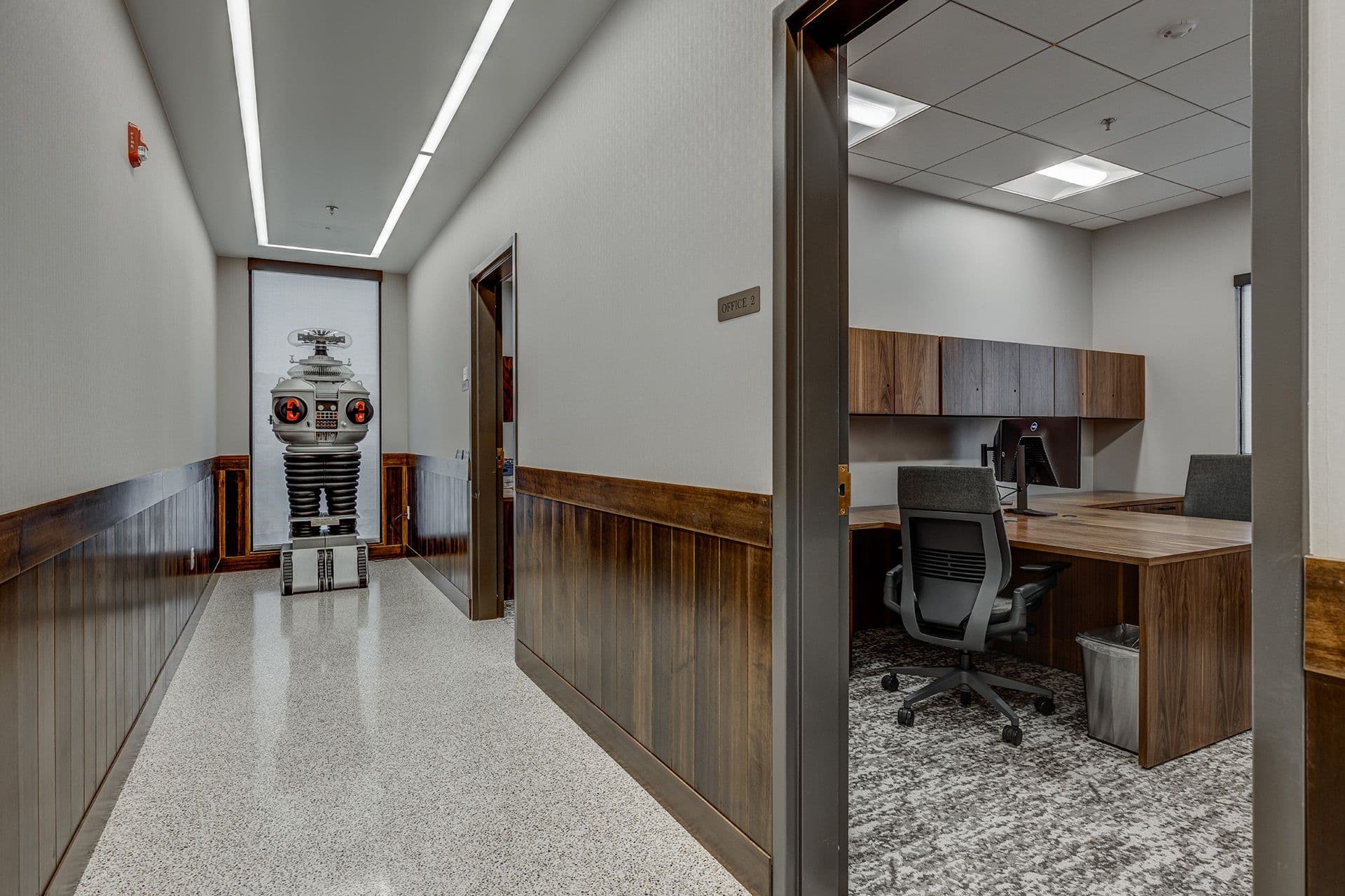 Corridor leading to doctors offices with novelty robot standing at the end