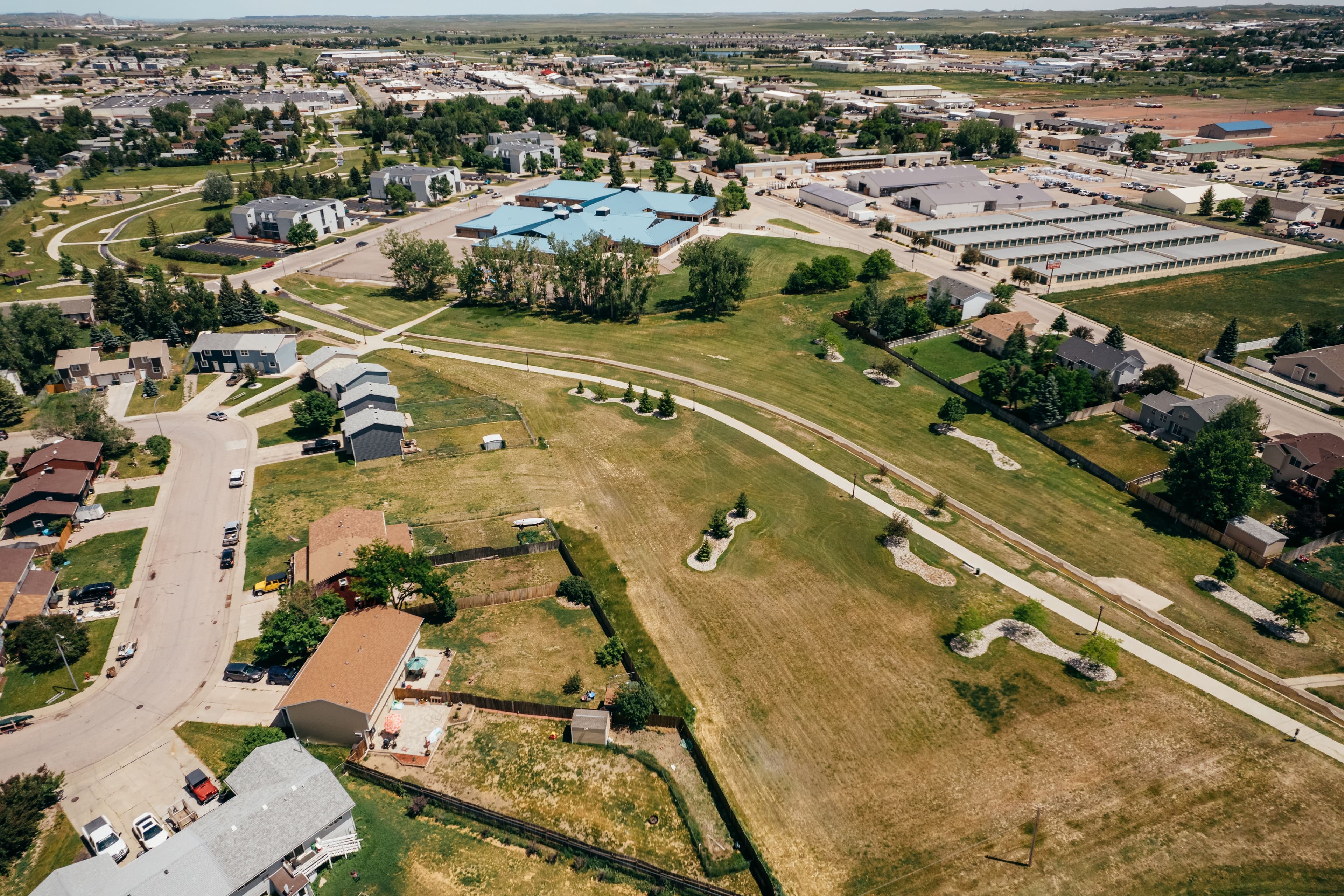 Ariel view of houses and gardens showing clinic with blue roof location